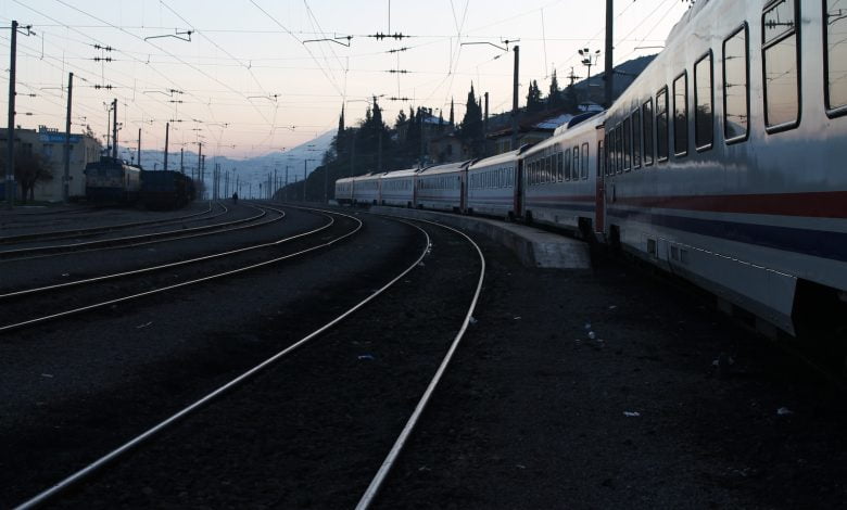 red and white train on rail road during daytime