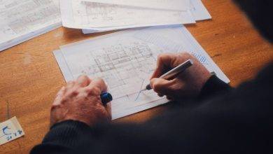 person writing on white paper