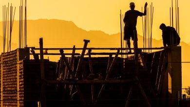 Silhouette of Workers on Construction Site