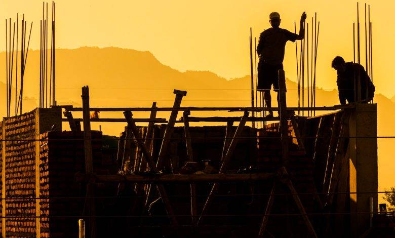 Silhouette of Workers on Construction Site