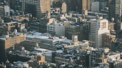 Aerial view of multistory residential buildings located on densely populated streets of megapolis district