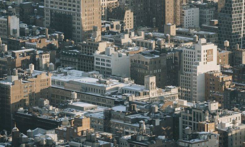 Aerial view of multistory residential buildings located on densely populated streets of megapolis district
