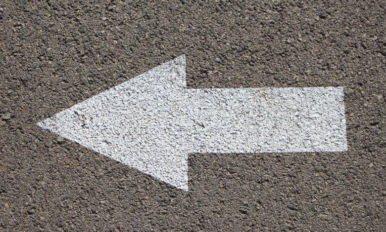white arrow road sign