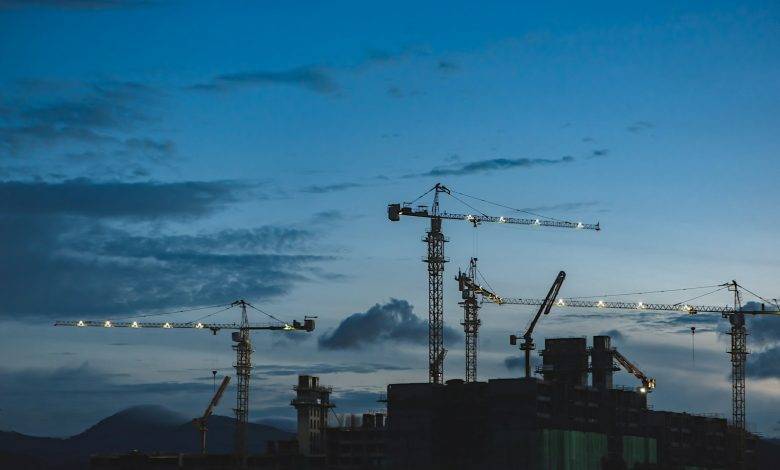 several cranes above the buildings